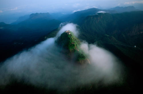 Adam's Peak, in southern Sri Lanka, emerges from the mornng mists.